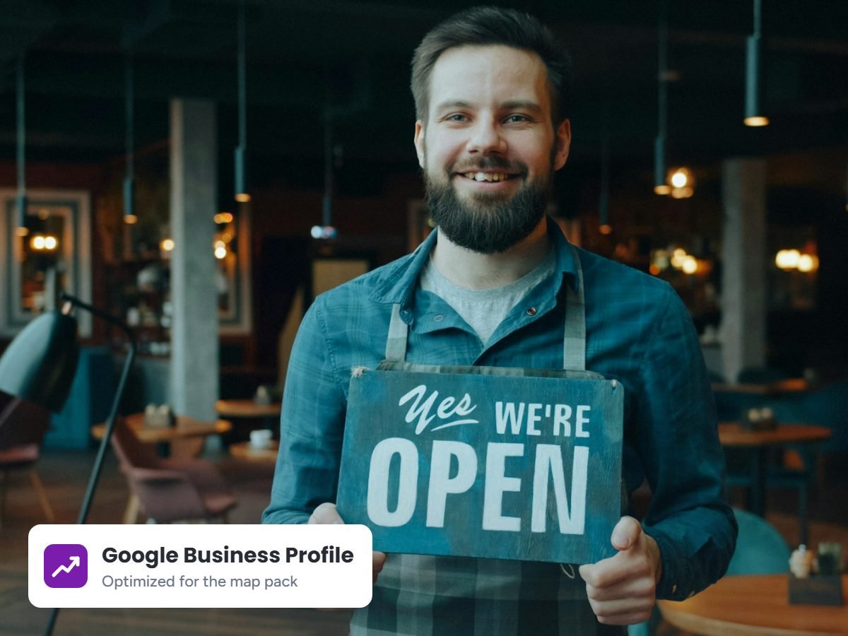 Small business owner holding an open sign, representing local SEO services