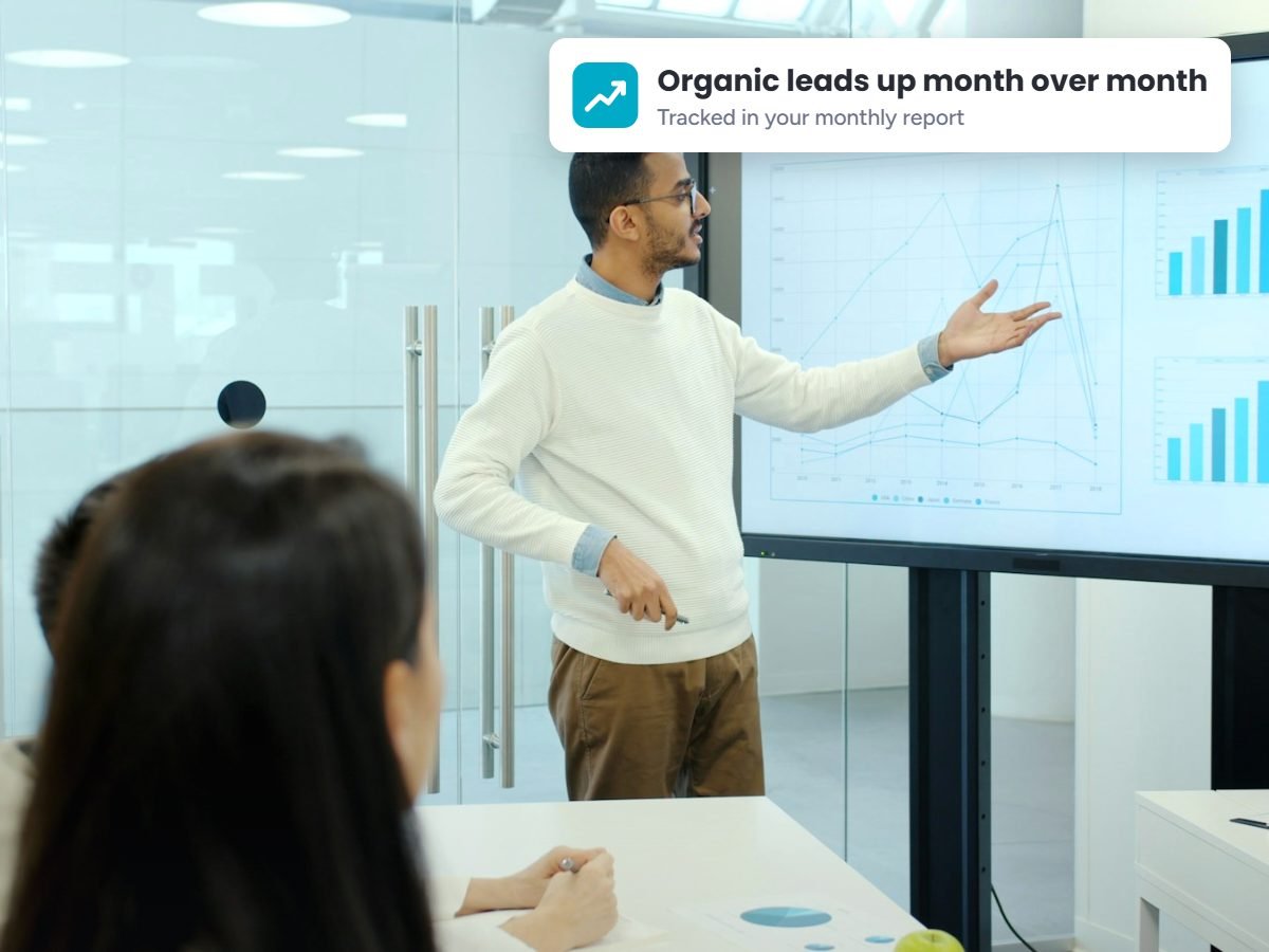 SEO strategist presenting monthly SEO results to a small business team