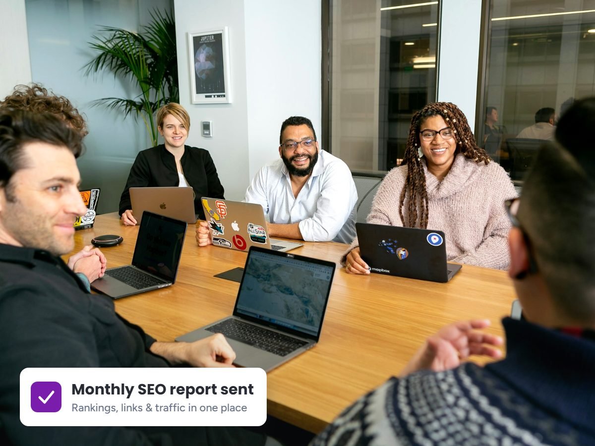 SEO agency team reviewing a client keyword strategy around a conference table