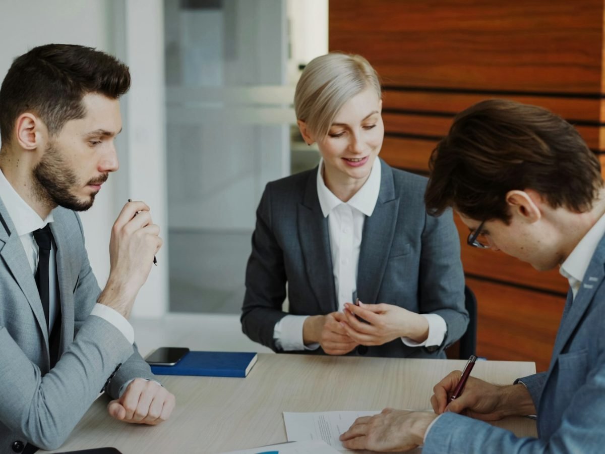Attorneys meeting with a client at a law firm office