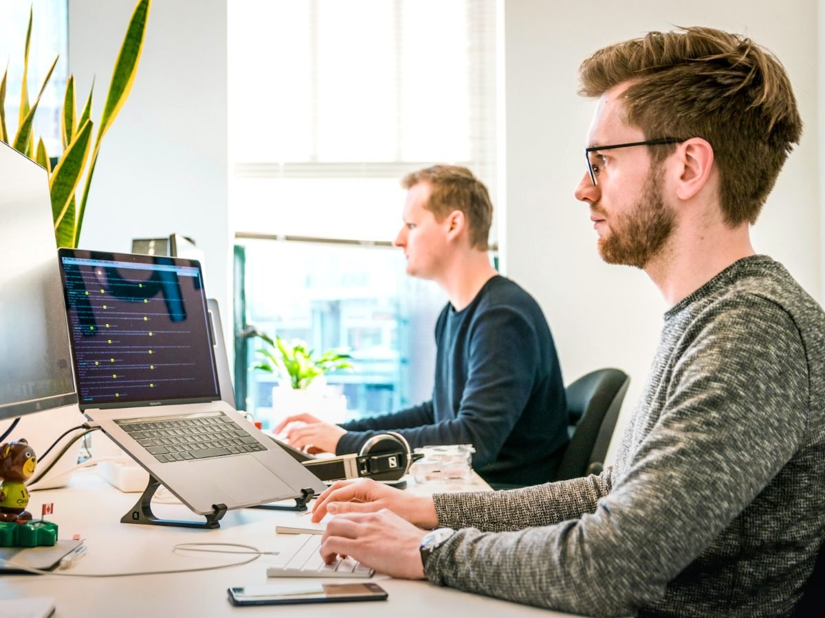 SaaS startup team working at computers in an open office