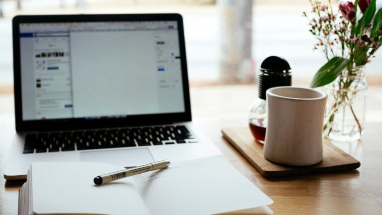Notebook and laptop on a desk while planning contextual backlinks